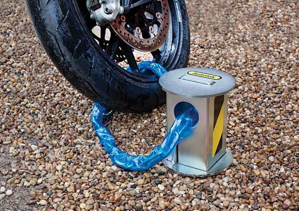 bike secured to a telescopic bollard on a drive