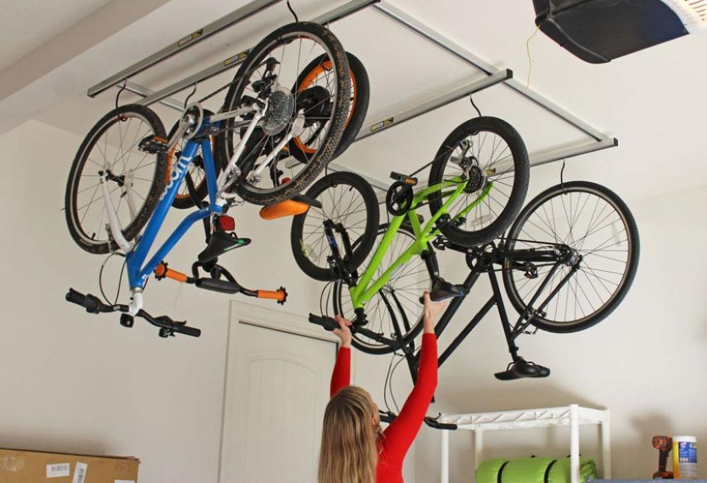 bikes being placed into a ceiling rack