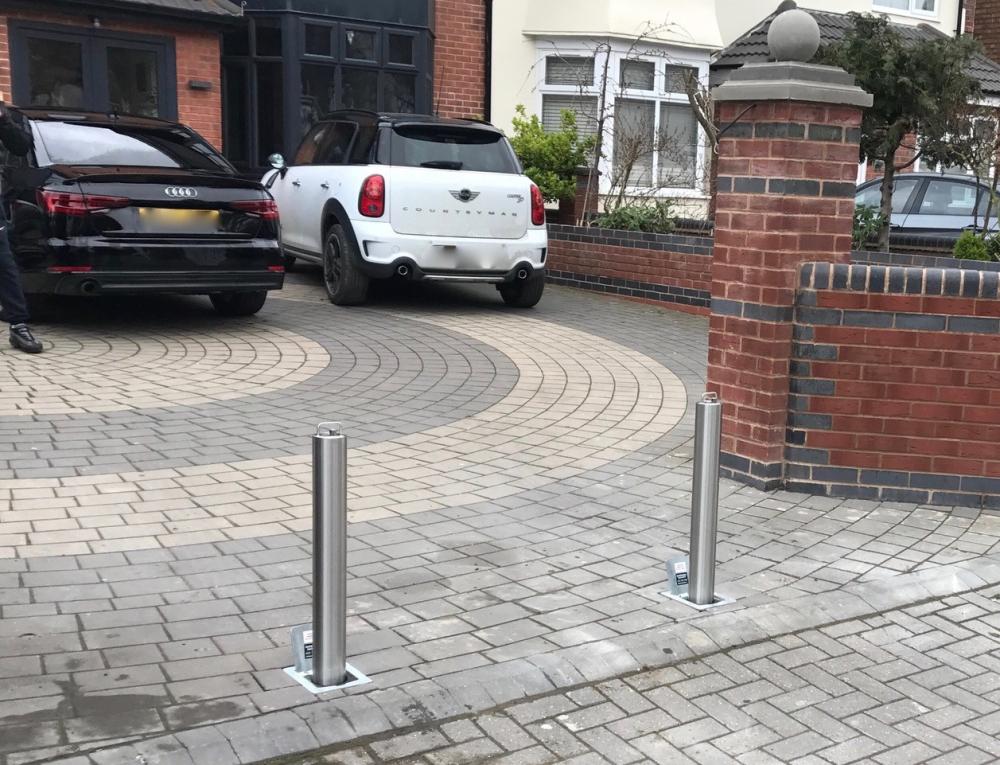 2 stainless steel driveway bollards with cars